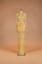 Sihëna Honeyed Lace — gold halter off-shoulder beaded-lace column gown with corset bodice and waist cutouts.