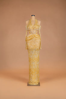 Sihëna Honeyed Lace — gold halter off-shoulder beaded-lace column gown with corset bodice and waist cutouts.
