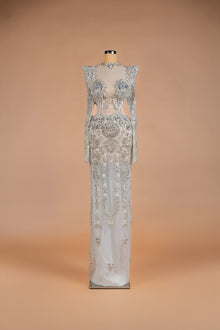 Sihëna Venetian Crystal — silver high-neck long-sleeve column gown with crystal floral beadwork on sheer nude illusion base.