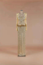 Sihëna Gilded Corset Column — gold square-neck long-sleeve crystal corset gown with beaded lace sleeves and column skirt.
