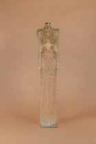 Sihëna Amber Aegis — gold high-neck long-sleeve column gown with a corseted crystal-beaded bodice.