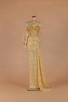 Sihëna Aureate Comet — gold illusion long-sleeve fitted gown with crystal-encrusted sheer corset bodice.