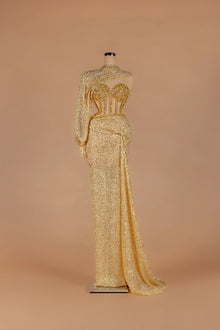 Sihëna Aureate Comet — gold illusion long-sleeve fitted gown with crystal-encrusted sheer corset bodice.