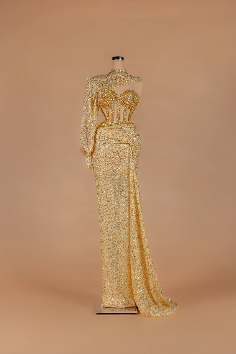 Sihëna Aureate Comet — gold illusion long-sleeve fitted gown with crystal-encrusted sheer corset bodice.