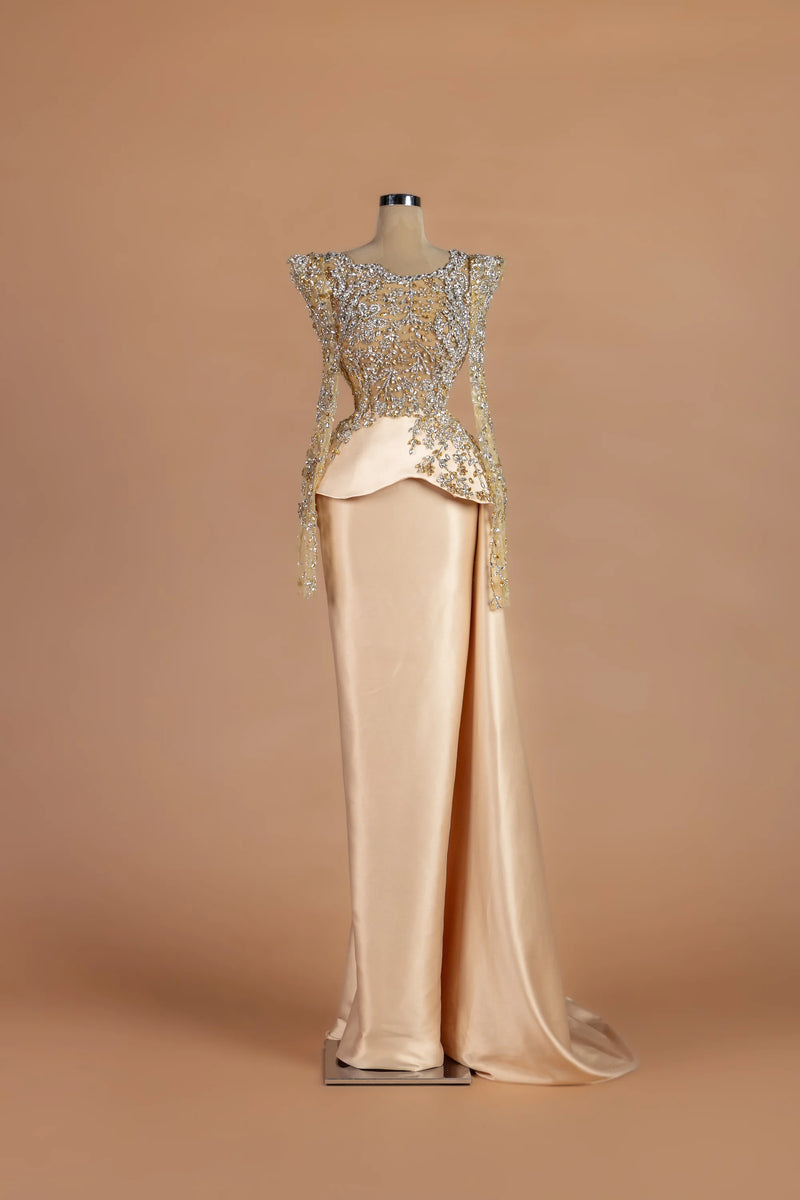 Sihëna Auric Solstice — champagne illusion long-sleeve column gown with a crystal-embroidered bodice.