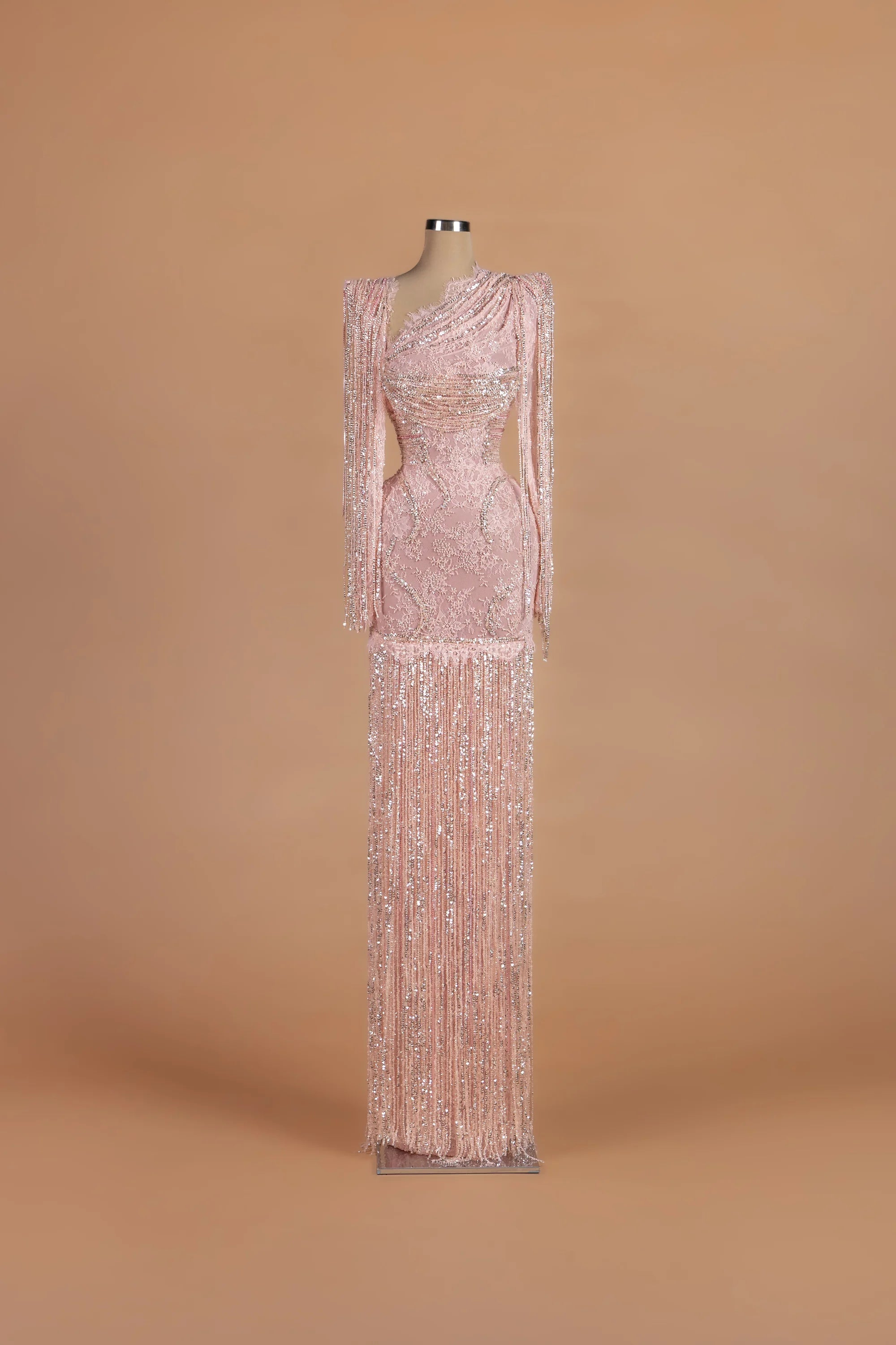Sihëna Blush Cadence — blush asymmetric long-sleeve column gown with sequin embellishment.