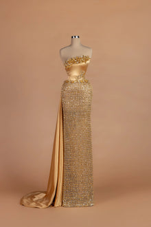 Sihëna Byzantine Tessera — gold strapless sleeveless column gown with 3D floral neckline appliqué.