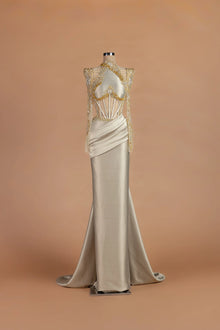 Sihëna Candlelight Fanfare — champagne illusion long-sleeve column gown with crystal beadwork.
