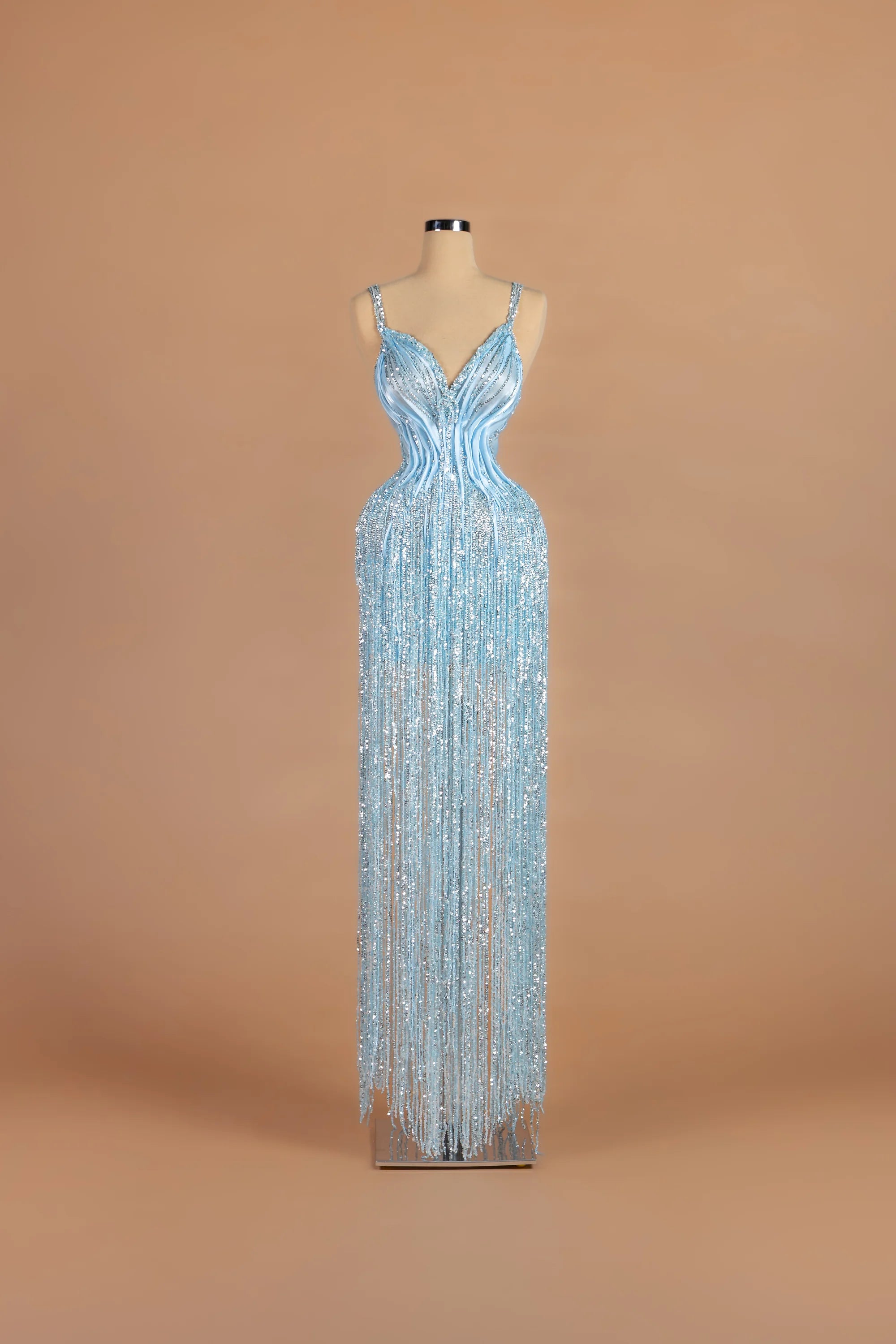 Sihëna Frost Fountain — powder-blue v-neck spaghetti-strap column gown with beaded sequin embellishment.