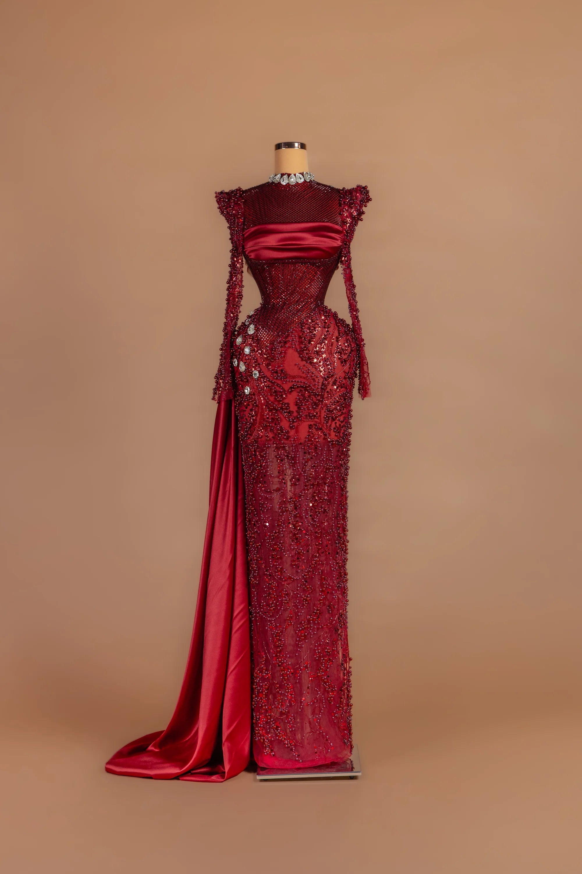 Sihëna Garnet Vesper — crimson high-neck long-sleeve column gown with crystal beading.