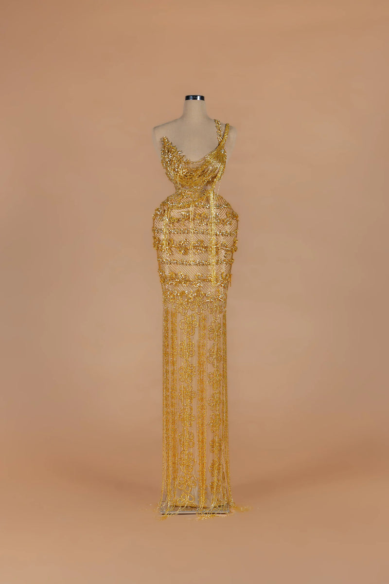 Sihëna Gilded Parure — gold asymmetric sleeveless column gown with draped crystal bead strands.