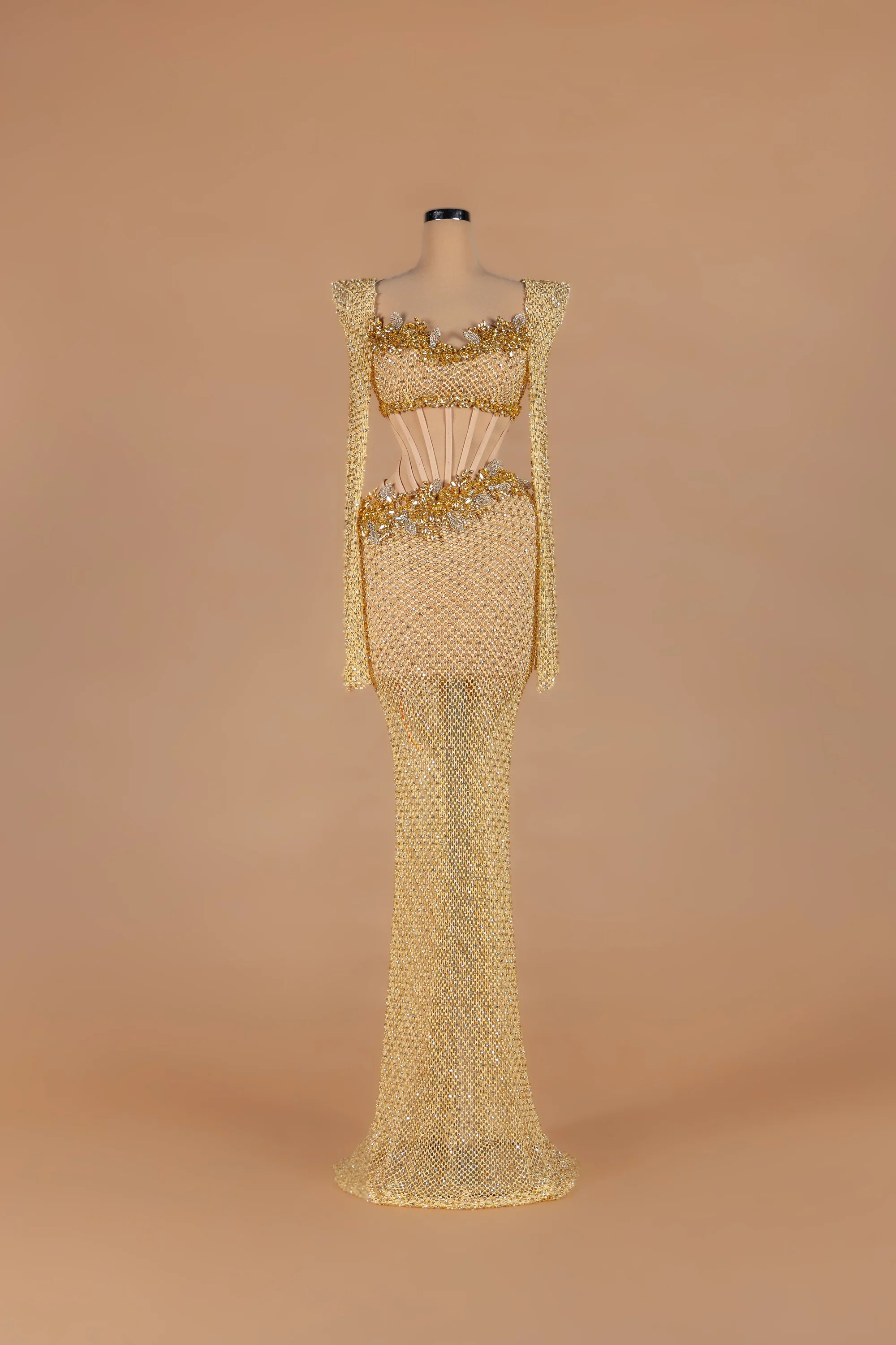 Sihëna Golden Nectar — gold strapless long-sleeve mermaid gown with crystal-beaded corset cutout waist.