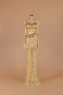 Sihëna Golden Nectar — gold strapless long-sleeve mermaid gown with crystal-beaded corset cutout waist.