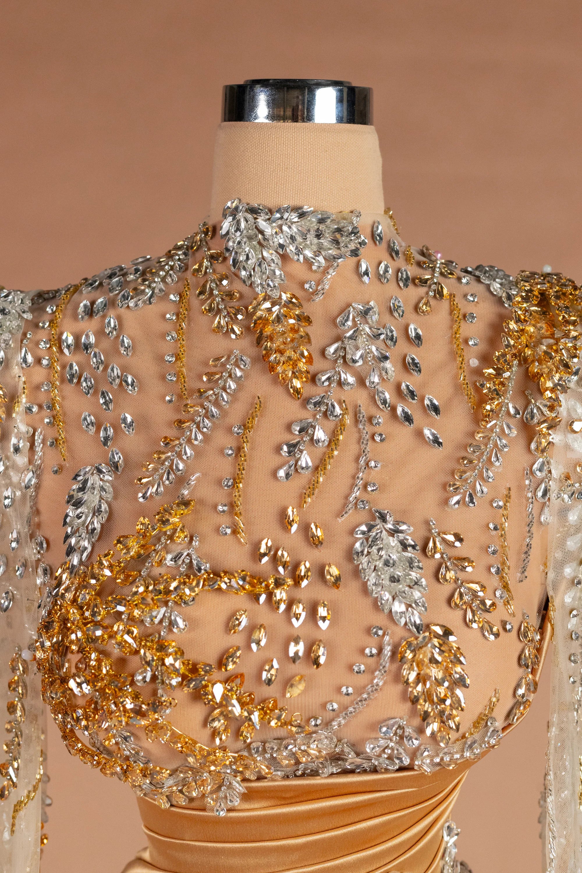 Sihëna وُرَيقاتُ الذهب — gold high-neck long-sleeve column evening dress