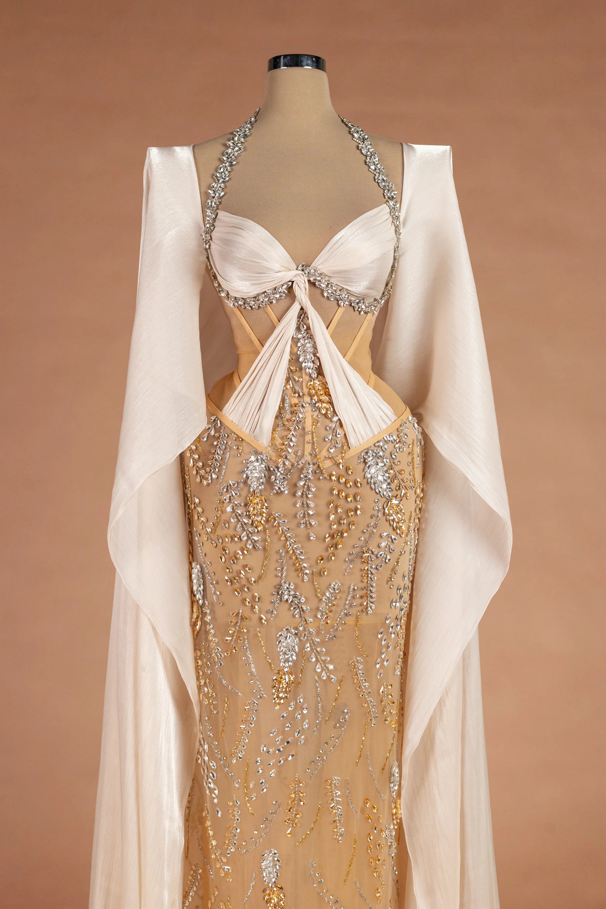 Sihëna غَلالَةُ القَمَر — champagne halter cape-sleeve column evening dress