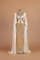 Sihëna Gossamer Moonrise — champagne halter cape-sleeve column gown with a crystal-trimmed corset bodice.