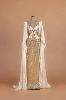 Sihëna Gossamer Moonrise — champagne halter cape-sleeve column gown with a crystal-trimmed corset bodice.
