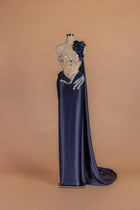 Sihëna Ink Rose — navy asymmetric sleeveless column gown with 3D floral detailing.