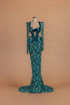 Sihëna Lagoon Marquise — teal asymmetric long-sleeve mermaid gown with lace appliqué.