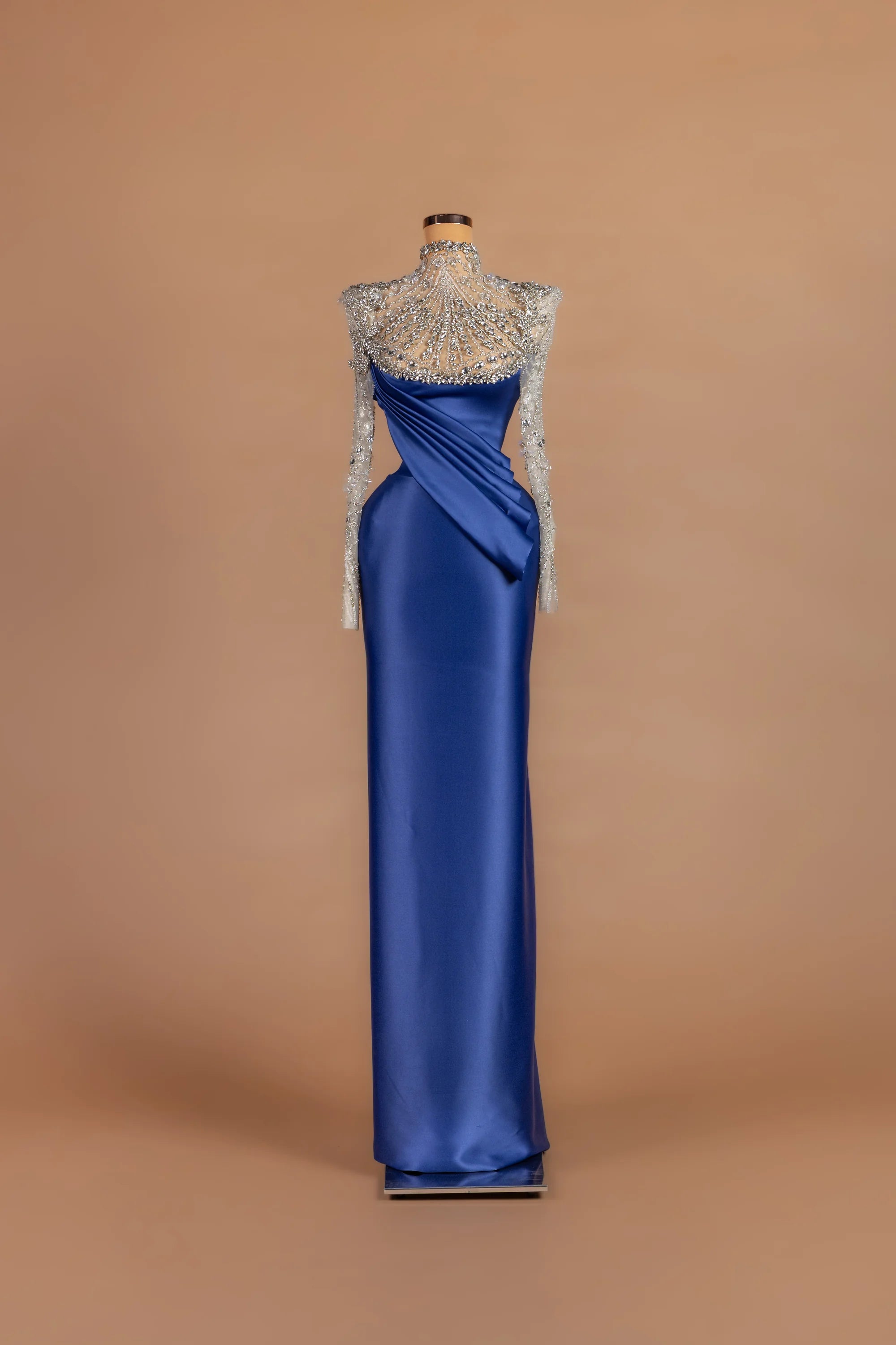 Sihëna Lapis Meridian — cobalt illusion long-sleeve column gown with a crystal-beaded sunburst yoke.