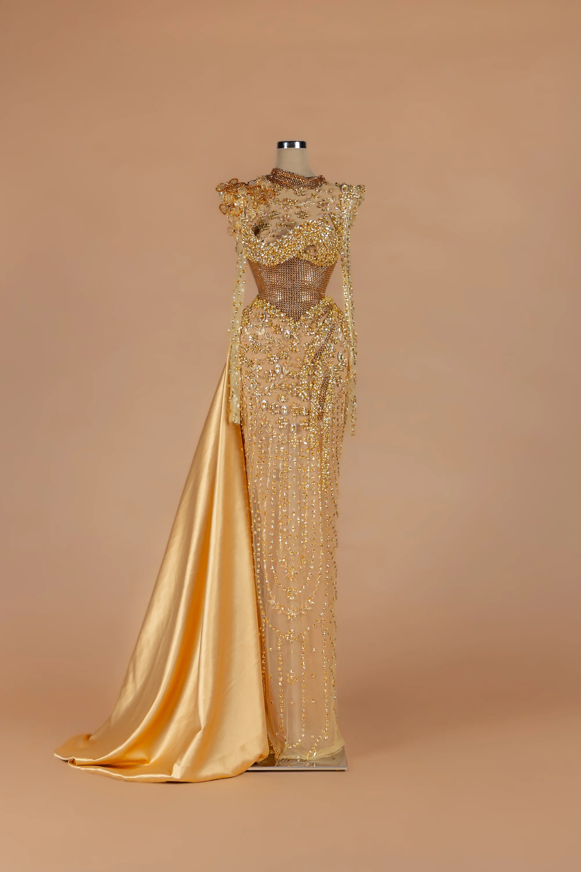 Sihëna Molten Regalia — gold high-neck long-sleeve column gown with a draped satin side train.