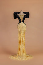 Sihëna Onyx Rivière — gold v-neck off-shoulder mermaid gown with cascading crystal chains at the neckline.