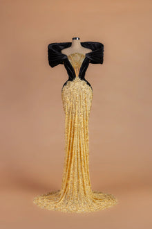 Sihëna Onyx Rivière — gold v-neck off-shoulder mermaid gown with cascading crystal chains at the neckline.