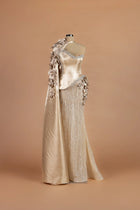 Sihëna Oyster Orchid — champagne asymmetric sleeveless column gown with a satin cape of crystal-studded 3D florals.