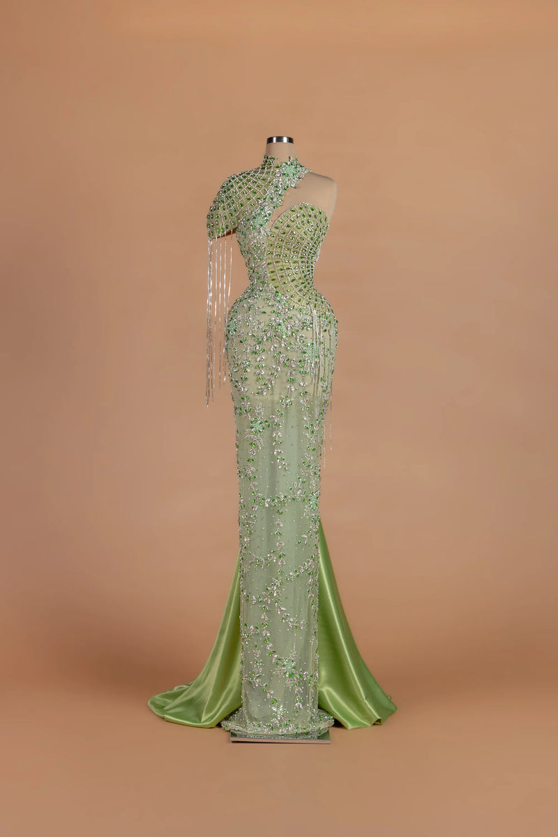 Sihëna Peacock Regalia — sage-green asymmetric sleeveless mermaid gown with crystal beading.
