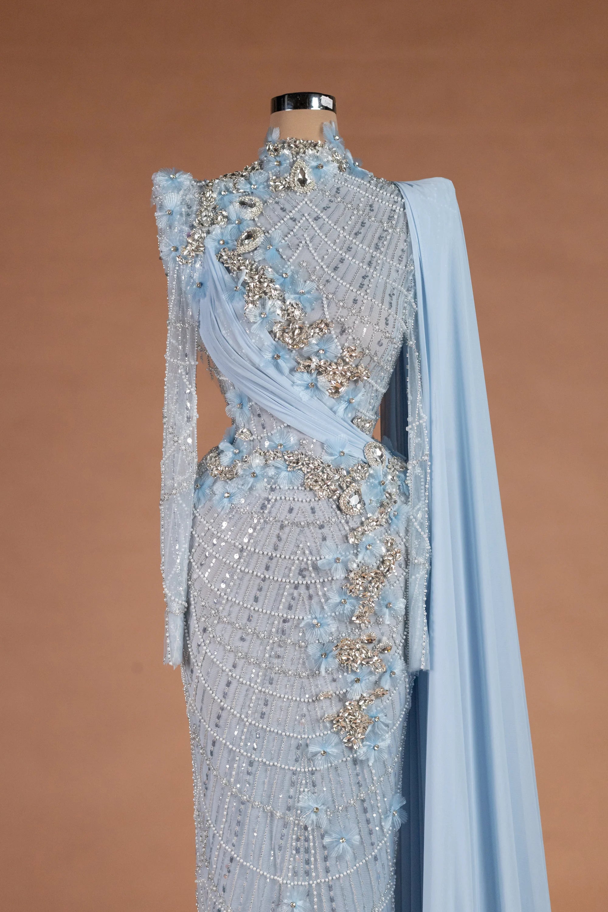 Sihëna لآلئُ الشتاء — powder-blue high-neck long-sleeve column evening dress