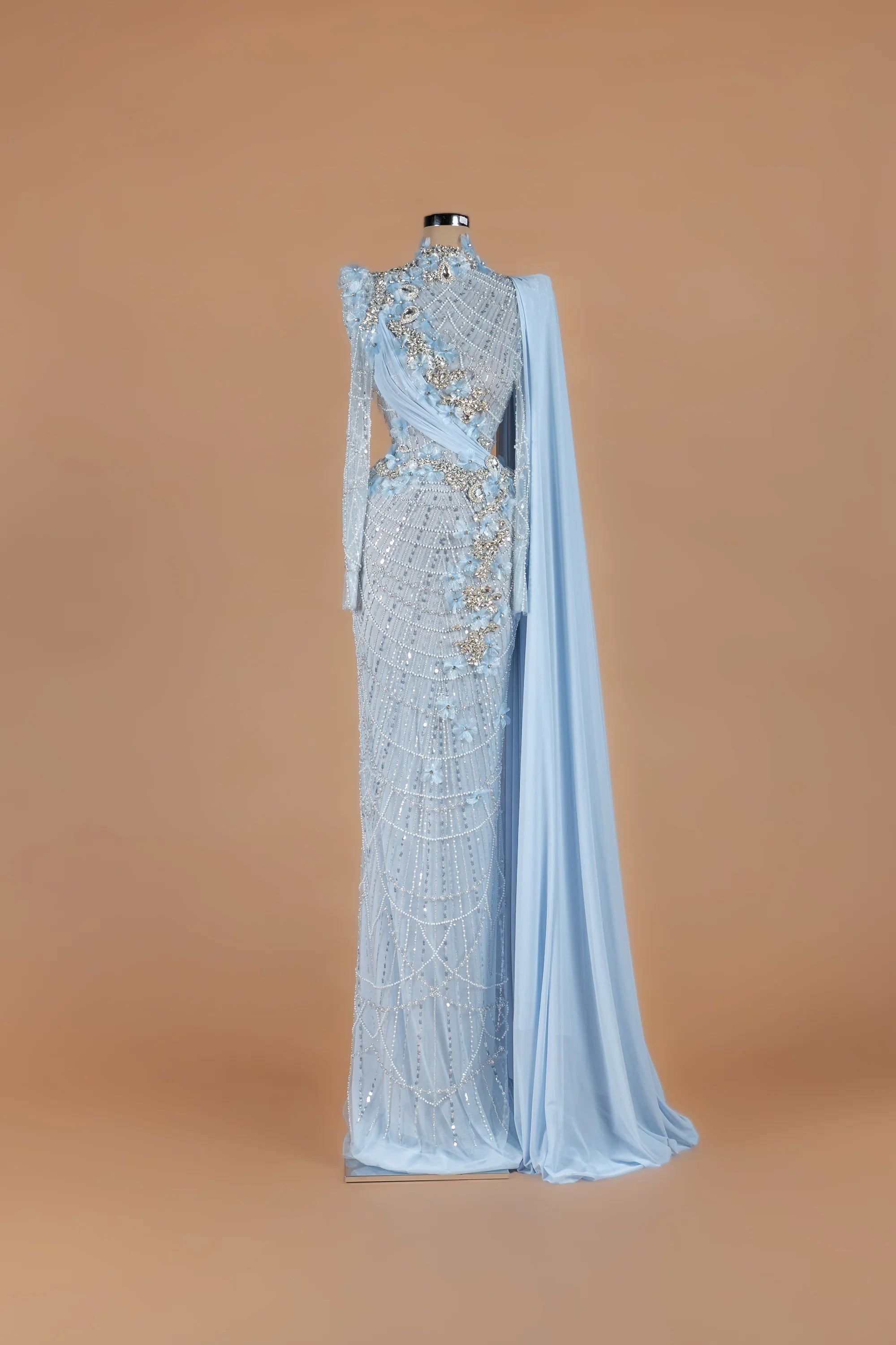 Sihëna Pearl Solstice — powder-blue high-neck long-sleeve column gown with draped pearl latticework.