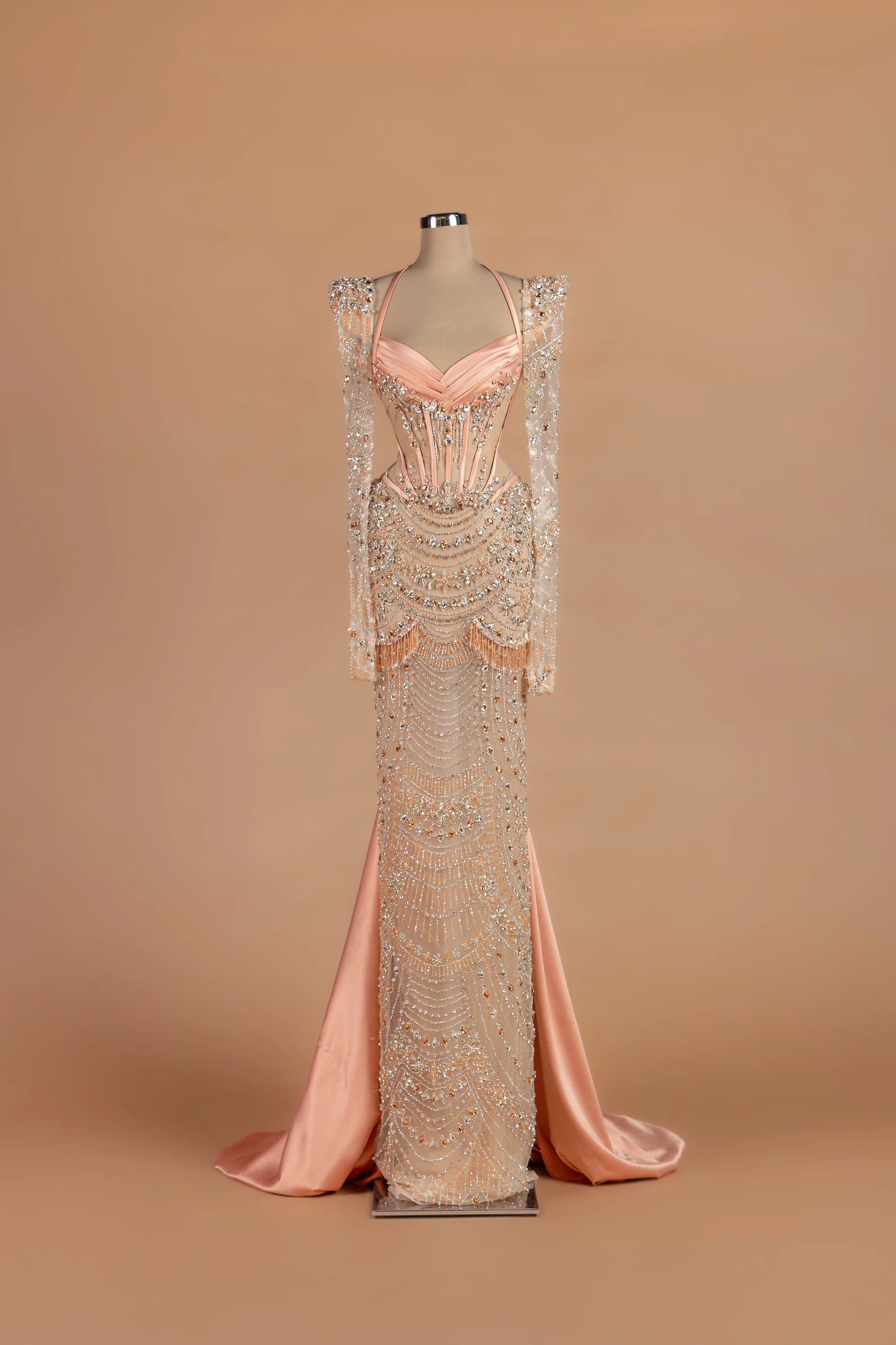 Sihëna Peony Sautoir — blush sweetheart long-sleeve sheath gown with cascading bead-strand swags.