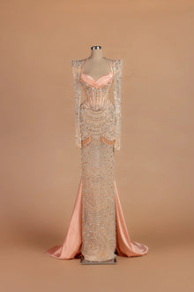 Sihëna Peony Sautoir — blush sweetheart long-sleeve sheath gown with cascading bead-strand swags.