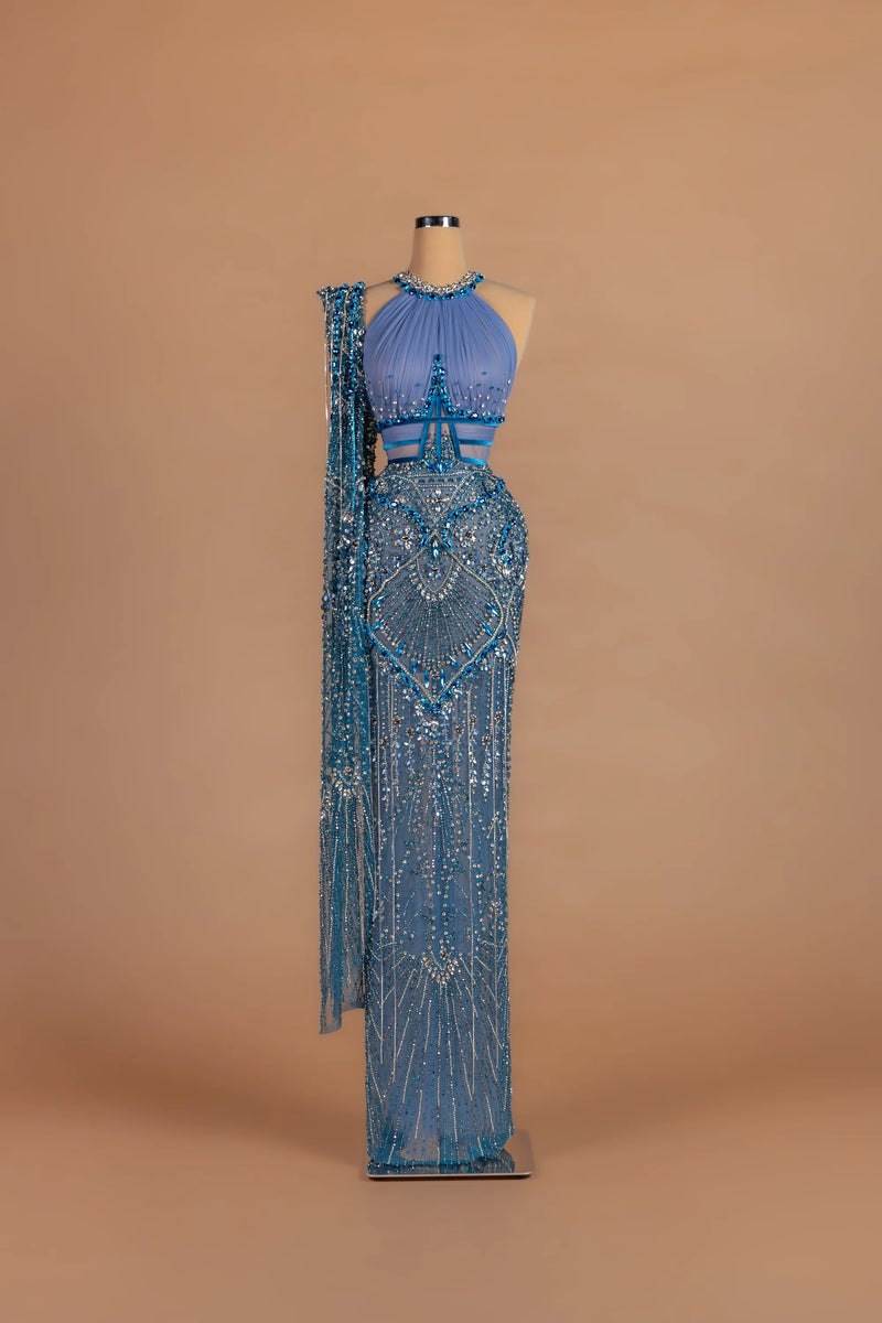 Sihëna Periwinkle Sunburst — powder-blue halter sleeveless column gown with radiating crystal beadwork.