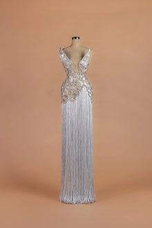 Sihëna Sterling Cloudburst — silver v-neck sleeveless column gown with beaded fan-motif bodice over a fringe skirt.