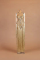 Sihëna Vermeil Chandelier — champagne illusion-neck sleeveless column gown with cascading fringe over crystal embroidery.