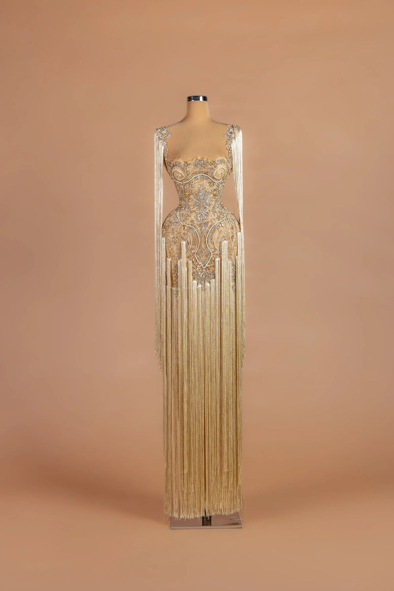 Sihëna Vermeil Chandelier — champagne illusion-neck sleeveless column gown with cascading fringe over crystal embroidery.